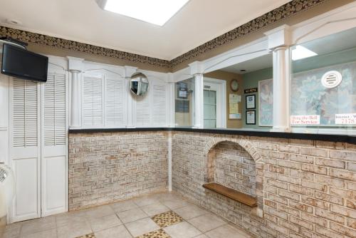 a brick fireplace in a room with a tv at Knights Inn Palmyra in Palmyra