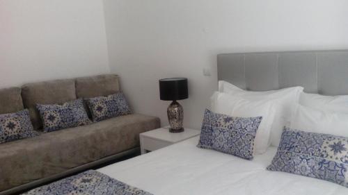 a living room with two beds and a couch at Pico Dreams in São Roque do Pico
