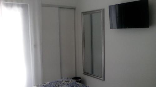 a bedroom with a mirror and a window and a bed at Pico Dreams in São Roque do Pico