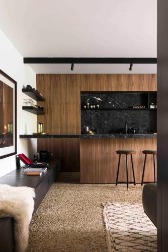 a living room with a black counter and a table at Loft Living Garden Suite in Nieuwpoort