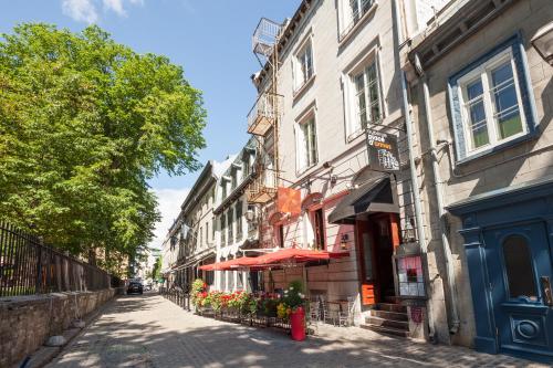 a street in a city with buildings and trees at Auberge Place d'Armes in Quebec City