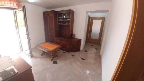 a room with a wooden cabinet and a mirror at Apartmaji Katrč in Soča