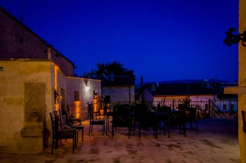 a group of chairs sitting in a courtyard at night at Yoruk Stone House in Nevsehir
