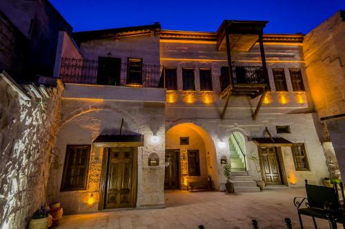 an old building with a bunch of doors at night at Yoruk Stone House in Nevsehir