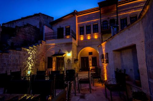 a building with chairs and tables in a courtyard at Yoruk Stone House in Nevsehir