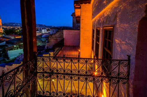 a balcony with a view of a city at night at Yoruk Stone House in Nevsehir