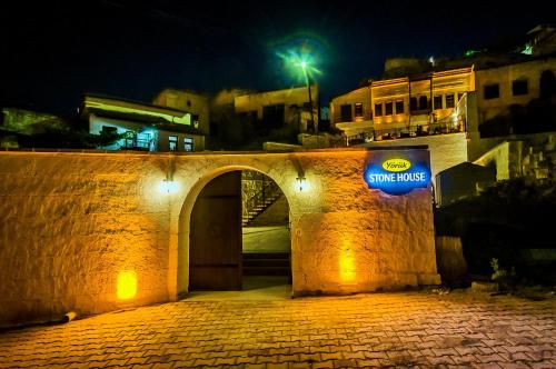 a stone bridge with a sign on it at night at Yoruk Stone House in Nevsehir