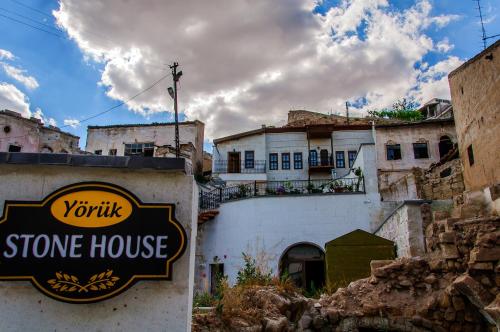 a stone house with a sign in front of it at Yoruk Stone House in Nevsehir
