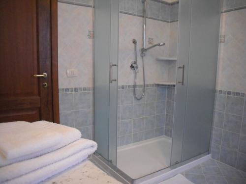 a shower with a glass door in a bathroom at B&B La Collina in Posada