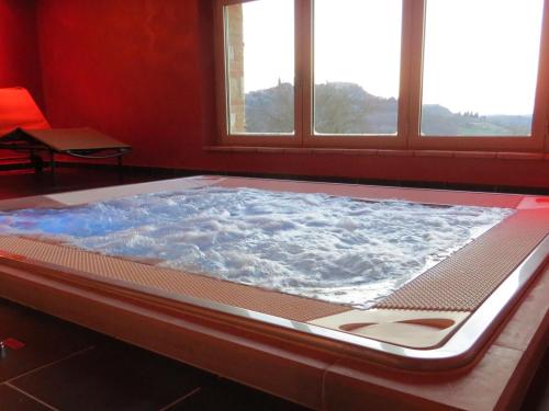 a large hot tub in a room with windows at Agriturismo Casale delle Lucrezie in Todi
