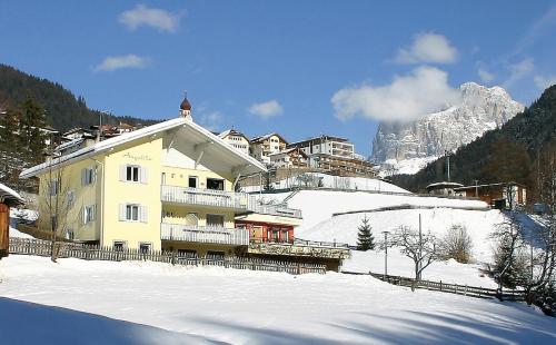 a building on top of a snow covered mountain at Haus Angelika in Nova Levante