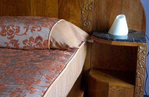 a bedroom with a bed with a lamp on a night stand at Casa Isabella in Vaglio Serra