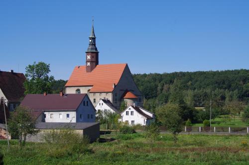 a large white building with a clock tower on top at Studniska Country Estate in Studniska