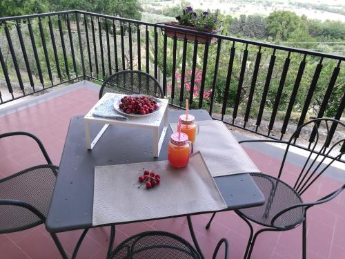 a picnic table with a bowl of fruit on a balcony at Agriturismo Etico Le Grazie in Bevagna