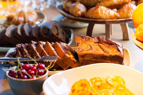 a table topped with different types of bread and pastries at One Suite Hotel in Mlini