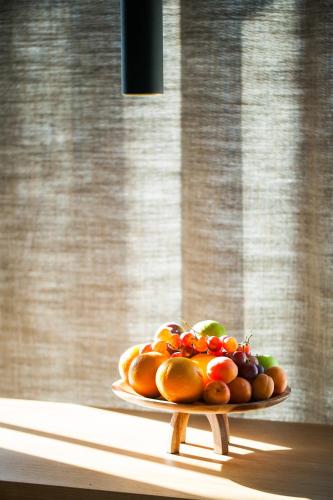a plate of fruit on a table in a window at One Suite Hotel in Mlini