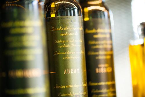 a row of bottles of wine on a shelf at One Suite Hotel in Mlini