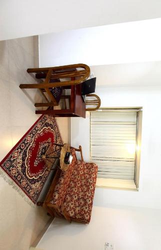 a group of ties hanging on a wall next to a window at Little Paradise Homestay in Kovalam