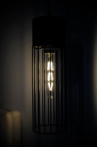 a light hanging from a wall in a dark room at Liberte Maisonettes in Parga
