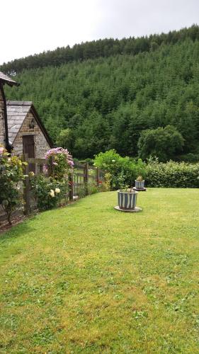 a garden with a bench in the middle of a yard at Middle Woodbatch B&B in Bishops Castle