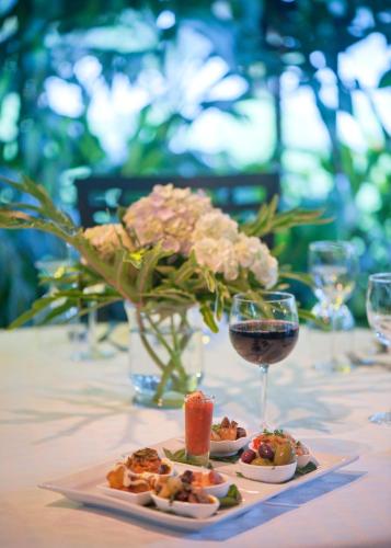 a table with a plate of food and a glass of wine at Hotel Panamonte in Boquete