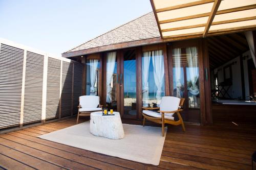 a balcony with two chairs and a table on a house at Sentidos Beach Retreat in Miramar
