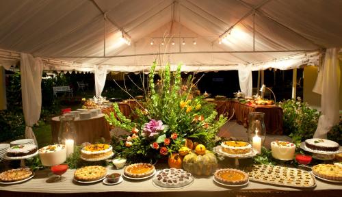 a table filled with pies and other food on a tent at Hotel Panamonte in Boquete