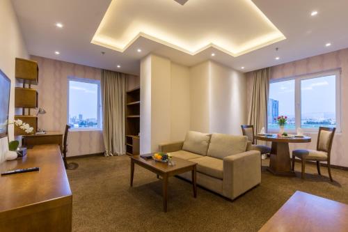 a living room with a couch and a table at La Roche Hotel in Erbil