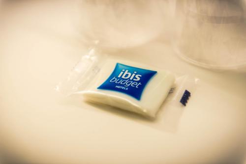 a tube of toothpaste sitting on top of a counter at ibis budget Troyes Est in Saint-Parres-aux-Tertres