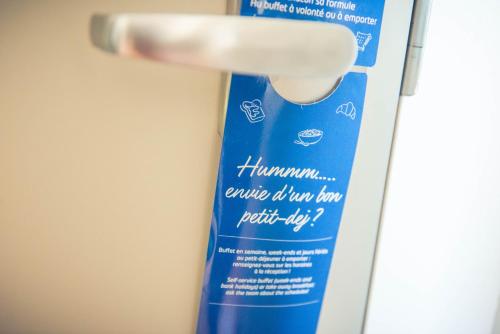 a tube of toothpaste sitting on top of a toothbrush at ibis budget Troyes Est in Saint-Parres-aux-Tertres