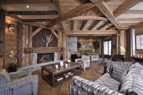 a living room with couches and a fireplace at CGH Résidences & Spas Le Jhana in Tignes
