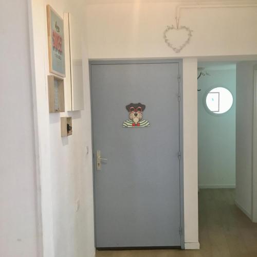 a door with a dog sticker on it at Gîte Atelier de Hansi - Colmar Centre in Colmar