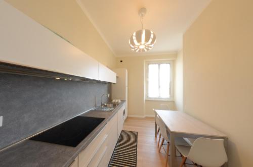 a kitchen with a table and a counter top at Blu Sea apartments in Pietra Ligure
