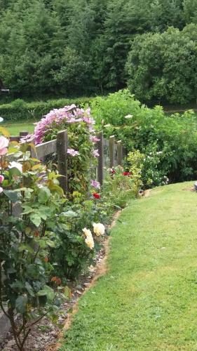 a garden with flowers and a wooden fence at Middle Woodbatch B&B in Bishops Castle