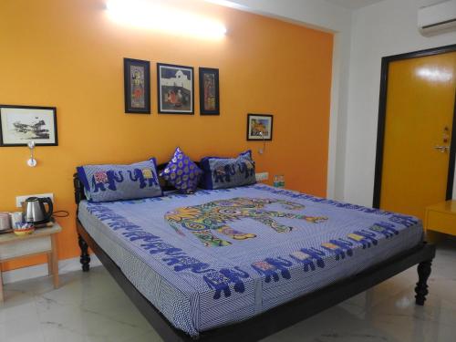 a bedroom with a large bed in a room at The Coral Tree Boutique Homestay in Agra