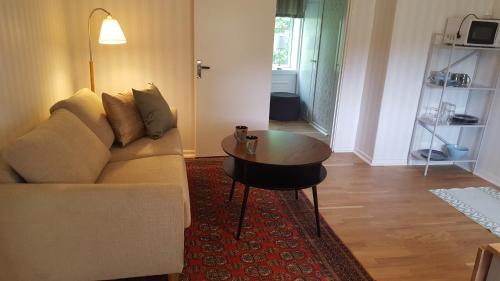 a living room with a couch and a table at Långshyttans Brukshotell in Långshyttan