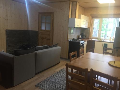a living room with a couch and a table at Metsaääre Accommodation in Uulu