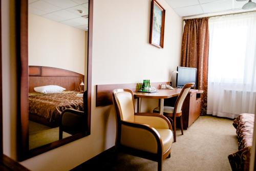 a hotel room with a table and a bed at Hotel Stal in Stalowa Wola