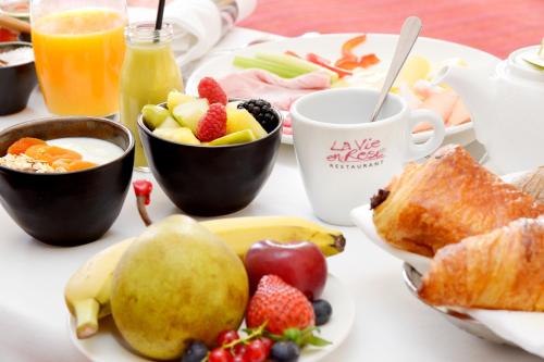 a breakfast table with fruit and a cup of coffee at Radisson Blu Hotel Toulouse Airport in Blagnac