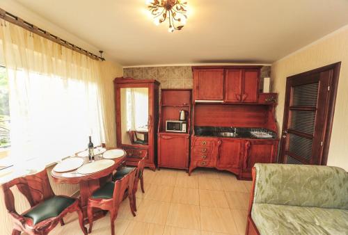 a living room with a table and a kitchen at Villa Dolphin Apartments in Petrovac na Moru