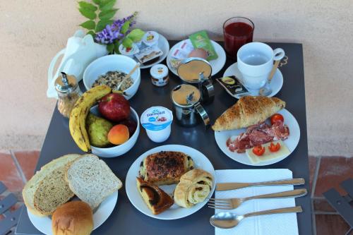 a table with plates of breakfast foods on it at Hotel Biscari in Catania