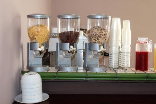 a shelf with four glass containers of food at Hotel Biscari in Catania
