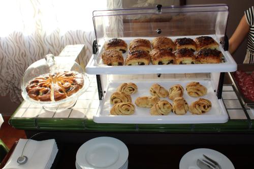 a display of pastries and pies on a table at Hotel Biscari in Catania