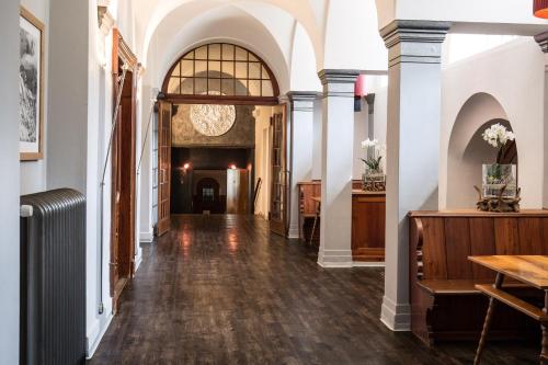 a hallway of a building with white walls and wooden floors at Kurhaus Lenzerheide in Lenzerheide