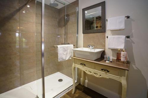 a bathroom with a sink and a shower at Greyhound Hever in Edenbridge