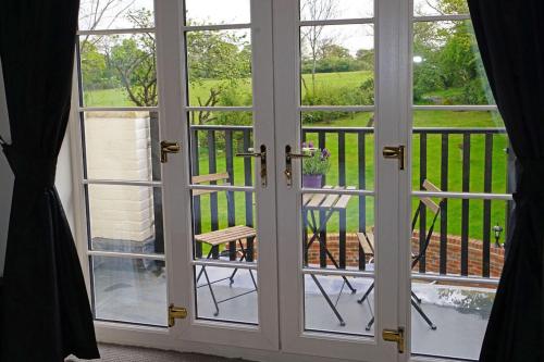 an open door with a view of a balcony at Greyhound Hever in Edenbridge