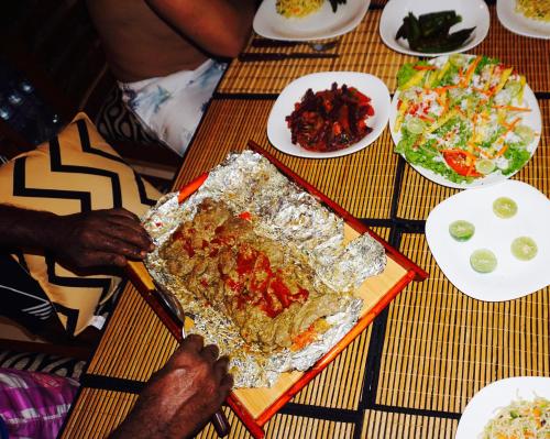 a table topped with food and plates of food at Sunset View Beach Hotel in Arugam Bay
