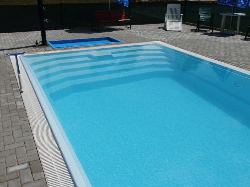 a large swimming pool with blue water at Hotel Formule in Děčín