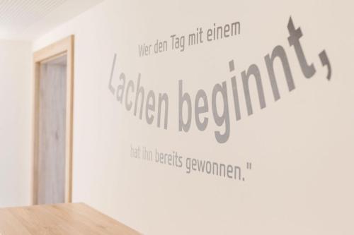 a wall with a sign that reads green regulation at R&R Residenzen HOTEL in Mitterbach