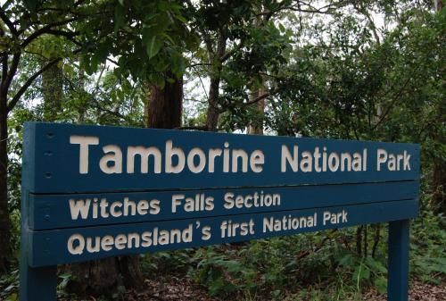 a blue sign for the tarmacarine national park at Witches Falls Cottages in Mount Tamborine